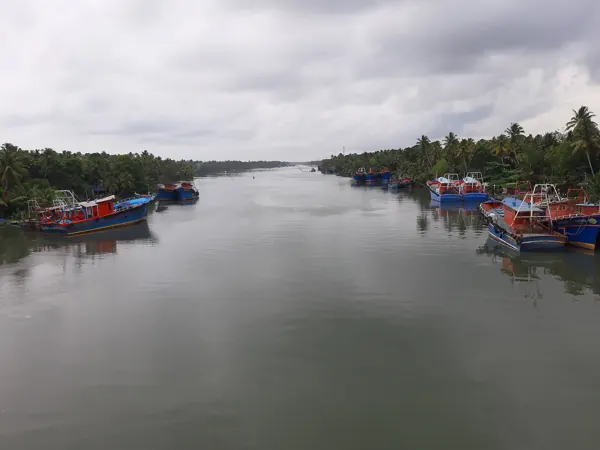 Amritapuri, Kollam coast – fishing boats on a cloudy evening (location photo, not the ashram buildings)