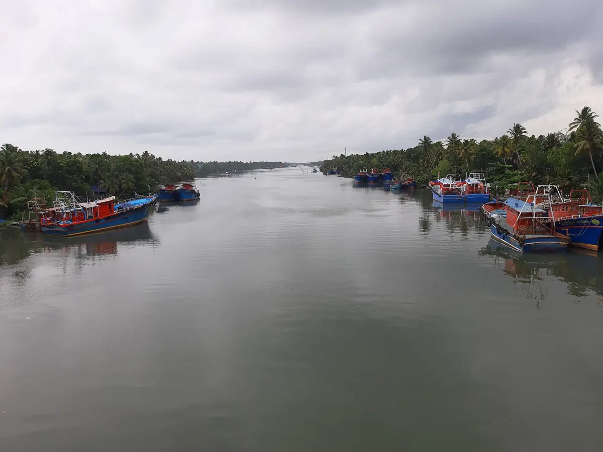 Amritapuri, Kollam coast – fishing boats on a cloudy evening (location photo, not the ashram buildings)